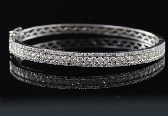 A modern 18k white gold and three row diamond set hinged bracelet, gross weight 21.2 grams.